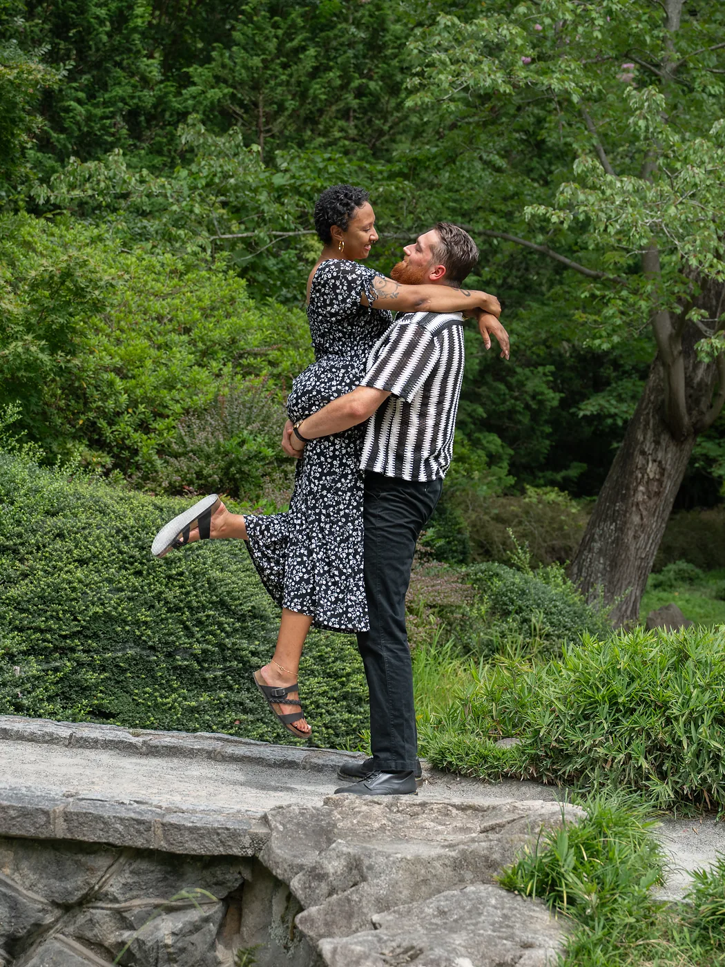 Joyful couples portrait lift on a stone bridge in the Japanese Garden at Maymont, Richmond Virginia