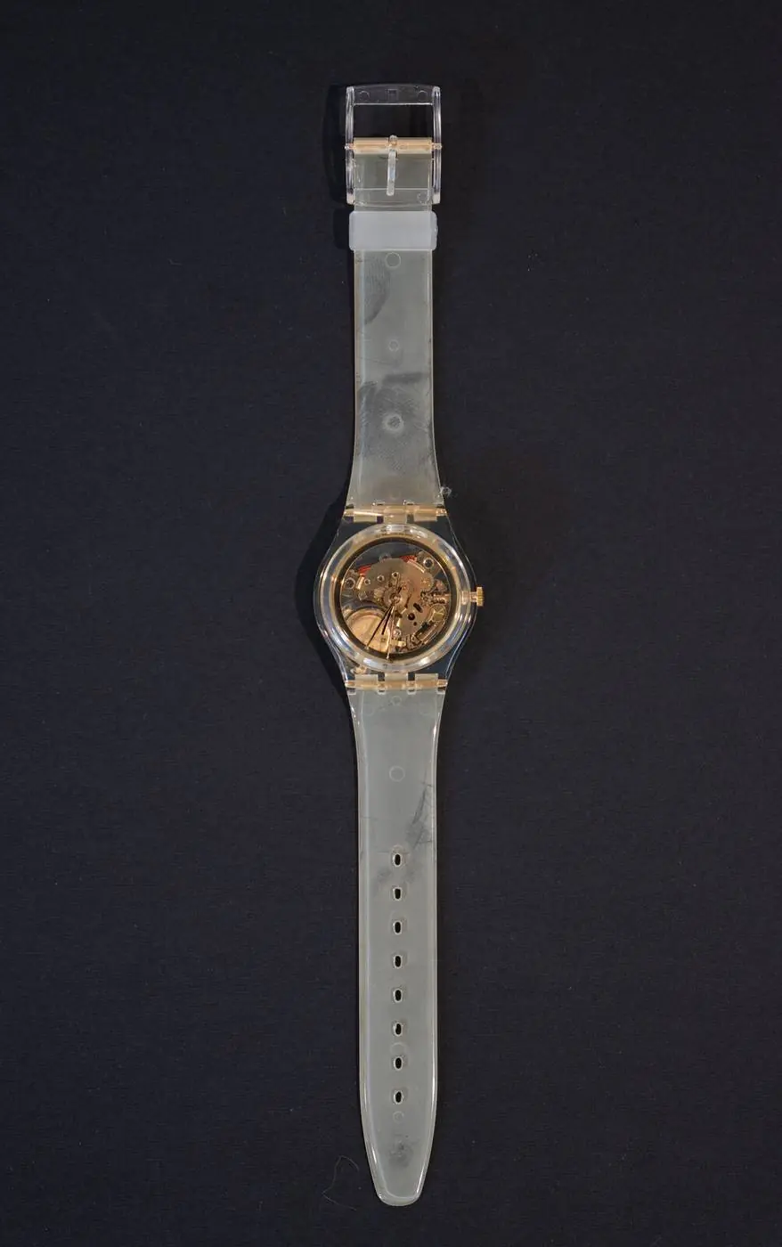 Product photography of a watch on black