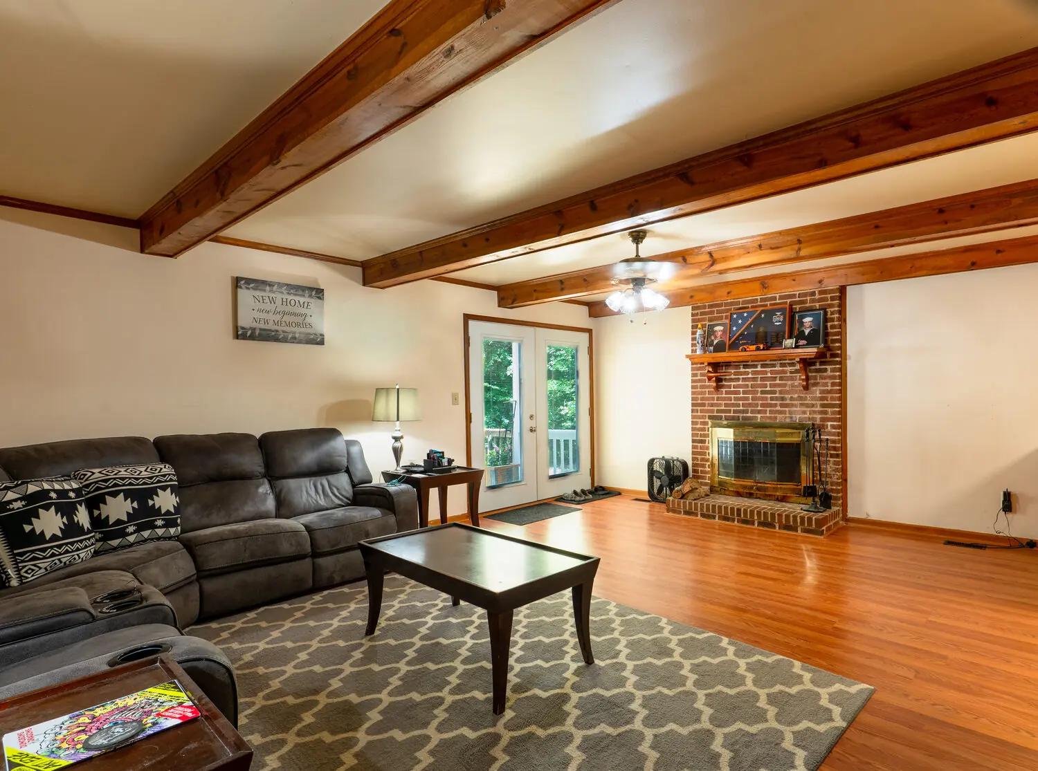 Living room with exposed wood beams and brick fireplace, greater Richmond VA
