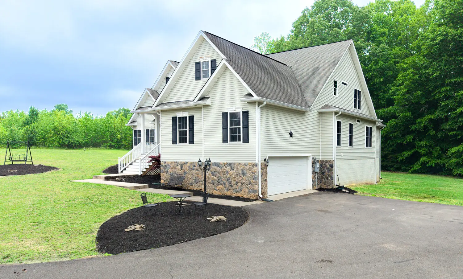 Side exterior of a cream home with stone accent and curved drive, greater Richmond VA