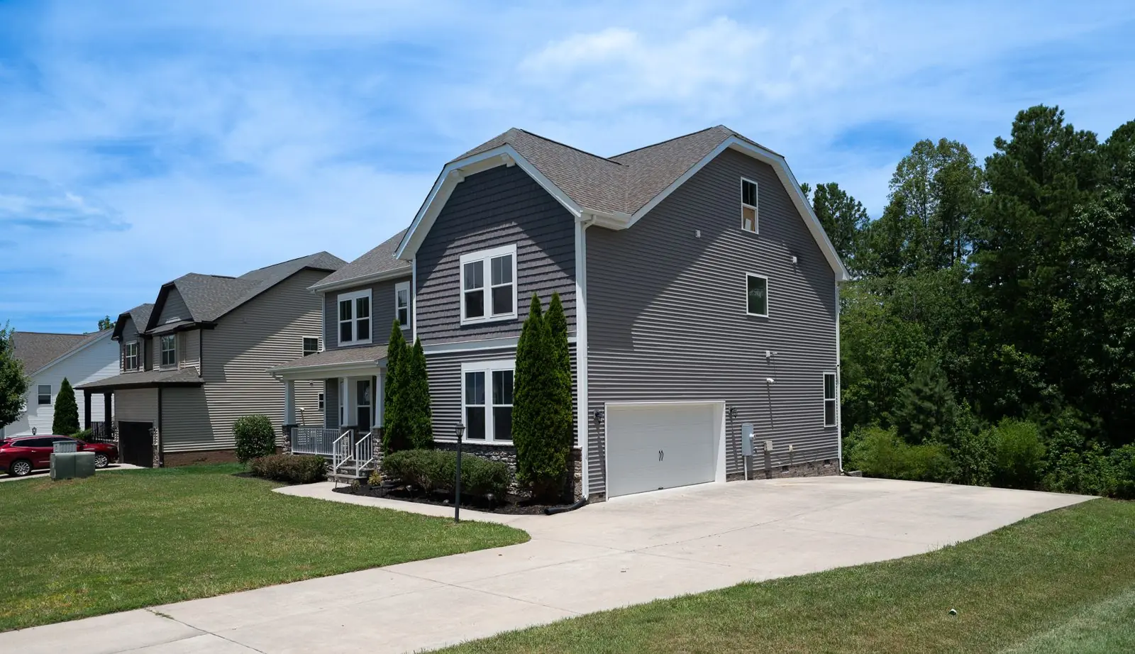 Front and side exterior of a gray two-story home with two-car garage, greater Richmond VA