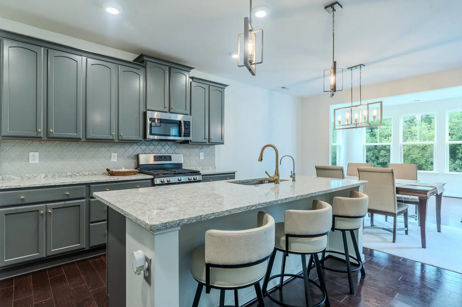 Gourmet kitchen with gray cabinetry, granite island, bar seating, and pendant lighting, greater Richmond VA