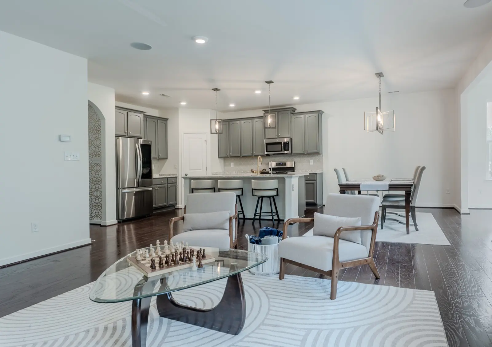 Open living and kitchen interior with gray cabinetry and hardwood floors, Henrico County VA